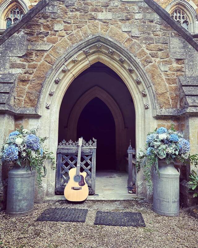 acoustic guitar in front of a church wedding ceremony