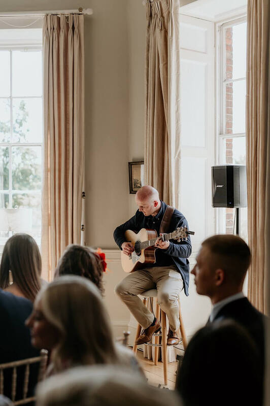 David williams guitarist performing live with his acoustic guitar, bose pa and audience during the ceremony at norwood park